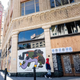 “A person walks by a boarded-up shop in Oakland, California on February 12, 2021. - Racial minorities have borne the brunt of the Covid-19 pandemic in the United States, with higher rates of death, unemployment and business failure, and less success obtaining federal government assistance intended to provide relief.”